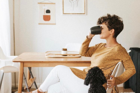 person drinking their morning cup of coffee